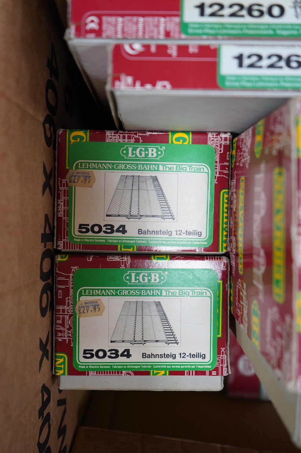 Seven boxes of Lehmann LGB G scale railway track sections, etc; two boxes of curved track sections (1500 and 1100), two Bahnsteig (5034), two sets of crossover points (12260), and a three-way set of points (1235). Condit